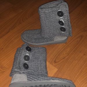 Grey UGG boots with three buttons down the side